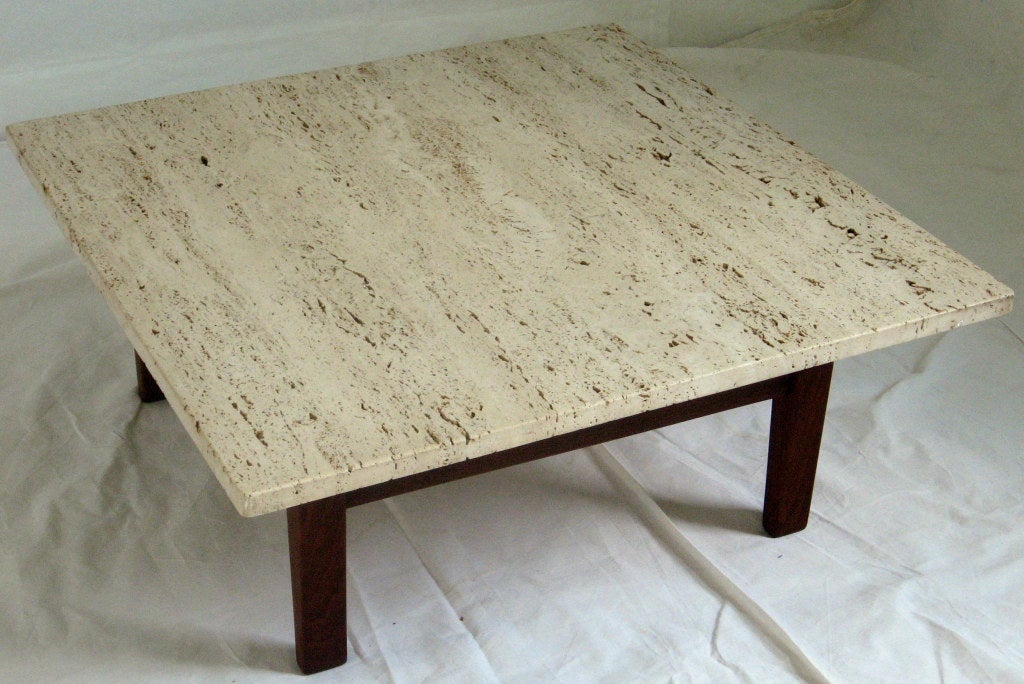 Elegant simple coffee table from the studio of Arden Riddle. A base of solid black walnut is topped by a travertine marble top. The choice of materials is similar to  Adrian Pearsall and Vladimir Kagan.
The frame is branded AR ARDEN RIDDLE 1969.