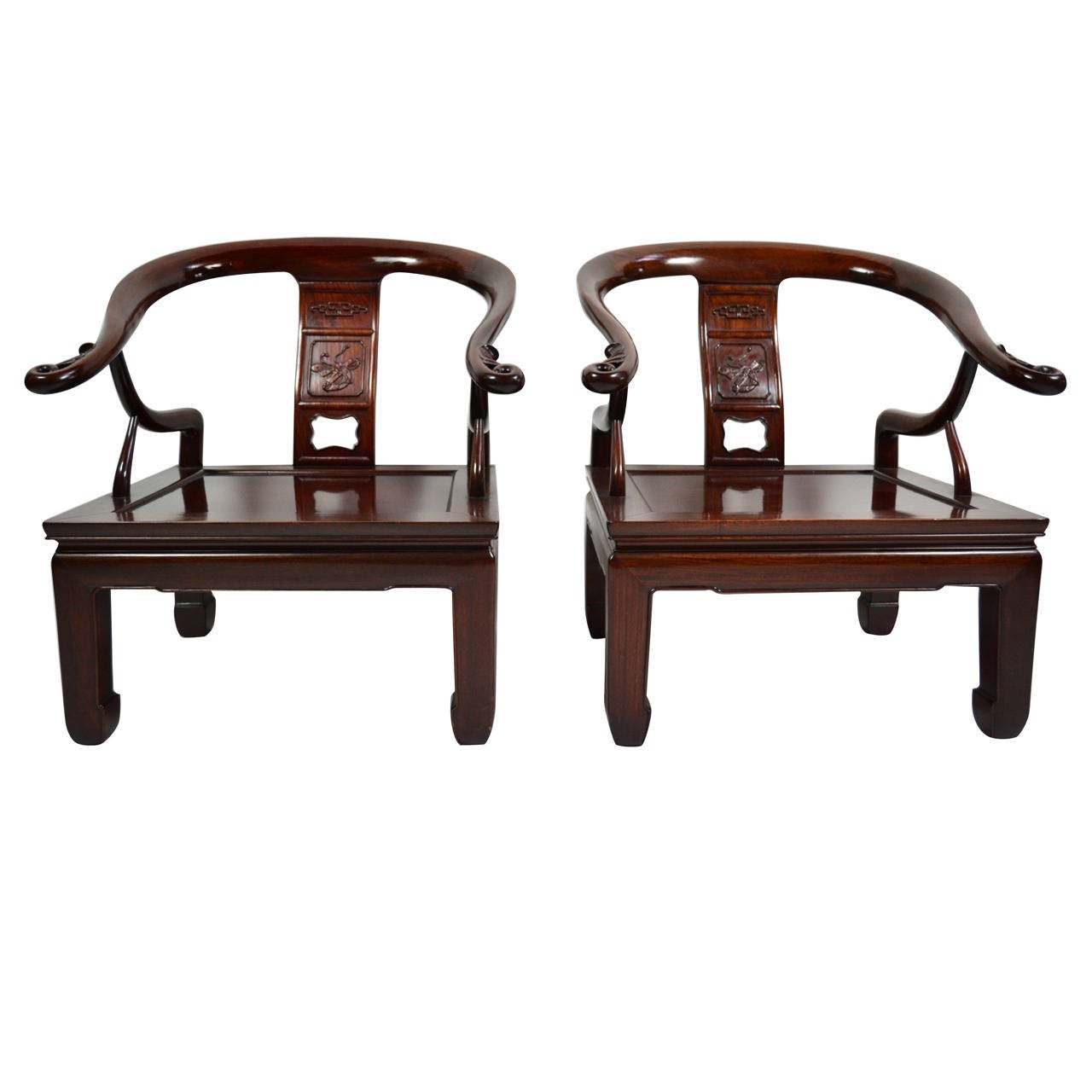 A pair of handcrafted 1960s solid rosewood lounge chairs in the Ming style of James Mont.
Acquired from a spectacular 1960s house on the coast of Maine.
The quality of the carving and the construction details are exceptional.
The chairs are in