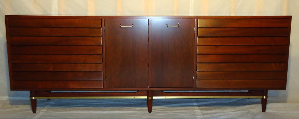 A classic louvered faced nine-drawer chest of drawers by Merton Gershun for his American of Martinsville Dania line. 
The chest of drawers has been professionally restored and is in excellent condition.

