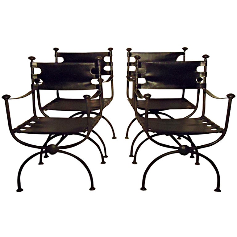 Suite of four antique black leather on antique black painted frames director's chairs. 

Original stitched leather seats and backs with leather cased metal band arm rests. 

The tubular frames and medallions are all hammered giving each chair