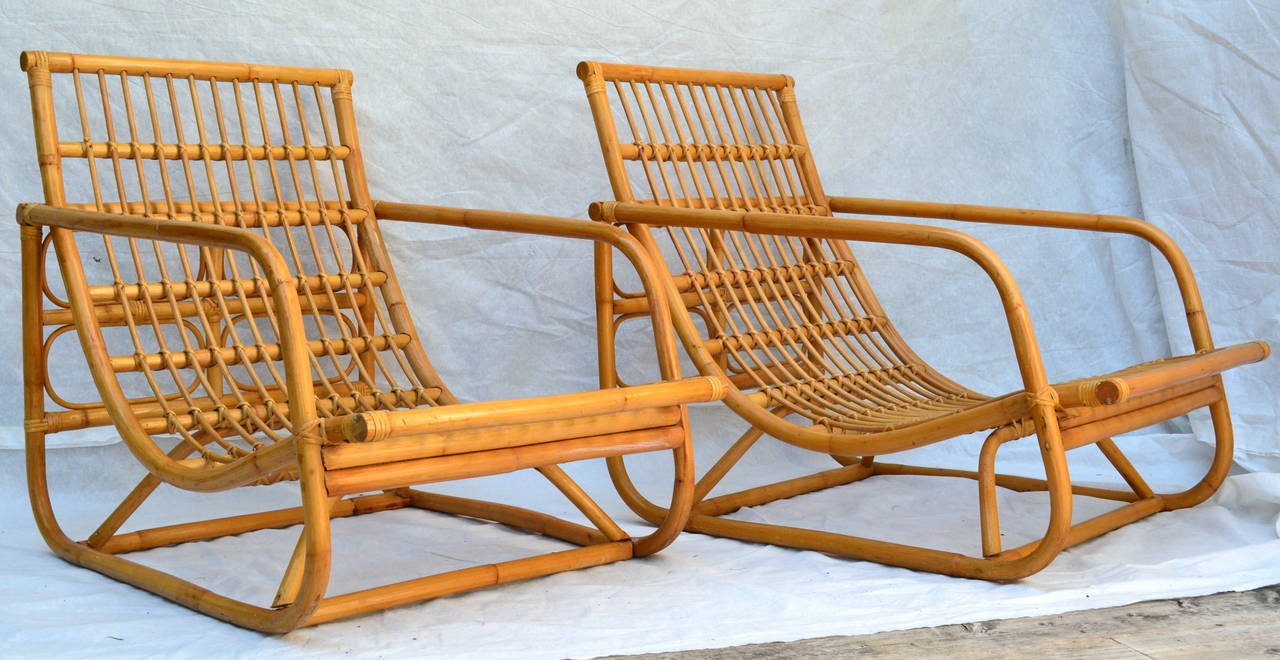 A very comfortable pair of rattan lounge chairs from the 1960's. Great profile.
The vintage upholstery consists of individual foam tubes cased in a light muslin  inserted into corduroy pockets. Each pocket is stitched lengthwise to the adjacent