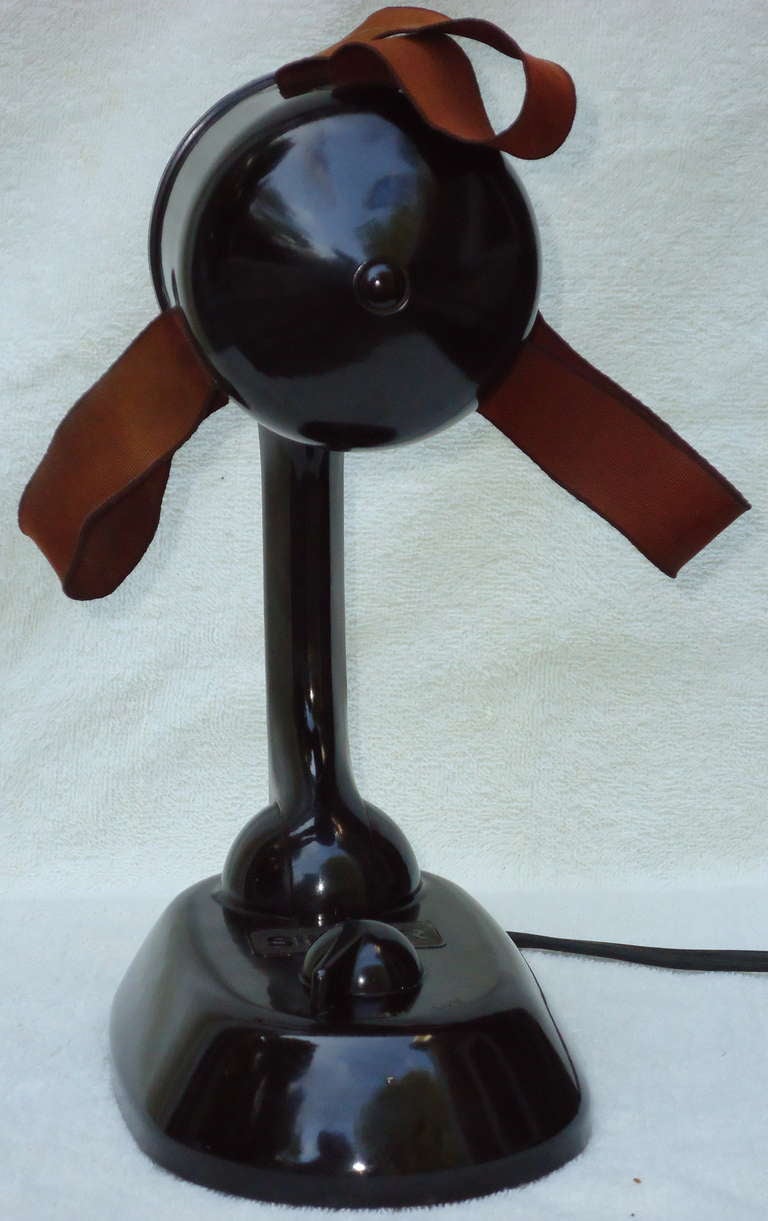 Built with Silk Ribbons for blades and a 3- speed motor, this Model 6-1 Ribbonaire Singer Fan with an adjustable Bakelite body is in great original condition. 
The instruction guide printed on the underside of the fan looks like it was printed
