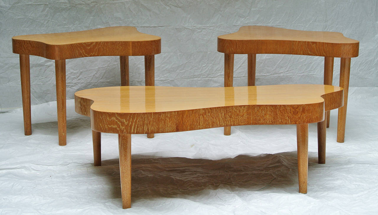 Rare beautifully constructed in the style of Paul Laszlo studio made mid-1950s cerused oak coffee table and a matched pair of end tables. These amoebic biomorphically shaped tables capture the best of that design era.
The tables have been