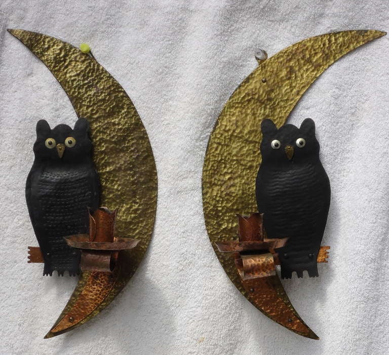 Whimsical pair of copper candle holders hand riveted to brass plated moons with hammered owls. Slightly different quirky sconces great for the cottage or anywhere two owls might hang out.
Slight loss of plating and minor other damage consistent