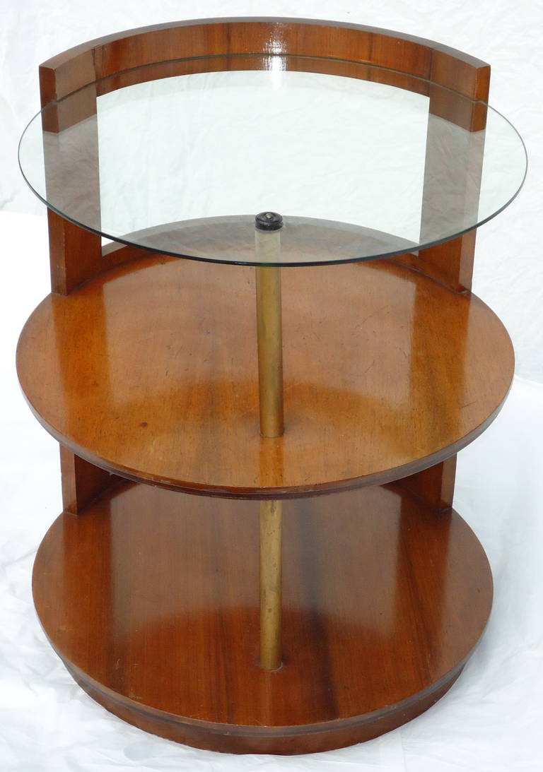 A rare Gilbert Rohde 3-tier walnut side table/ night stand designed for Herman Miller in the late1930's. 
A rare design because of its cut-out back
The table has its original glass top shelf and is in very good original condition with minor