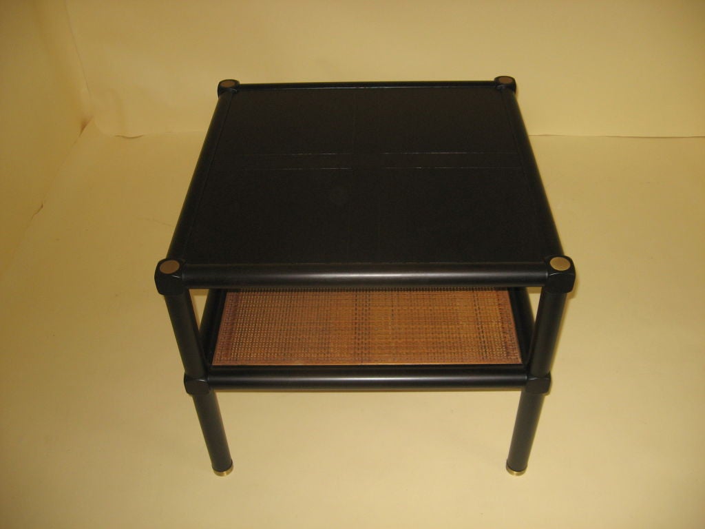 Simple Oriental influenced ebonized square side table. The top consists of 4 book matched veneer squares divided by an incised cross of closely grained walnut which contrasts with the strongly figured panels. Manufactured by Baker in the 1960's with