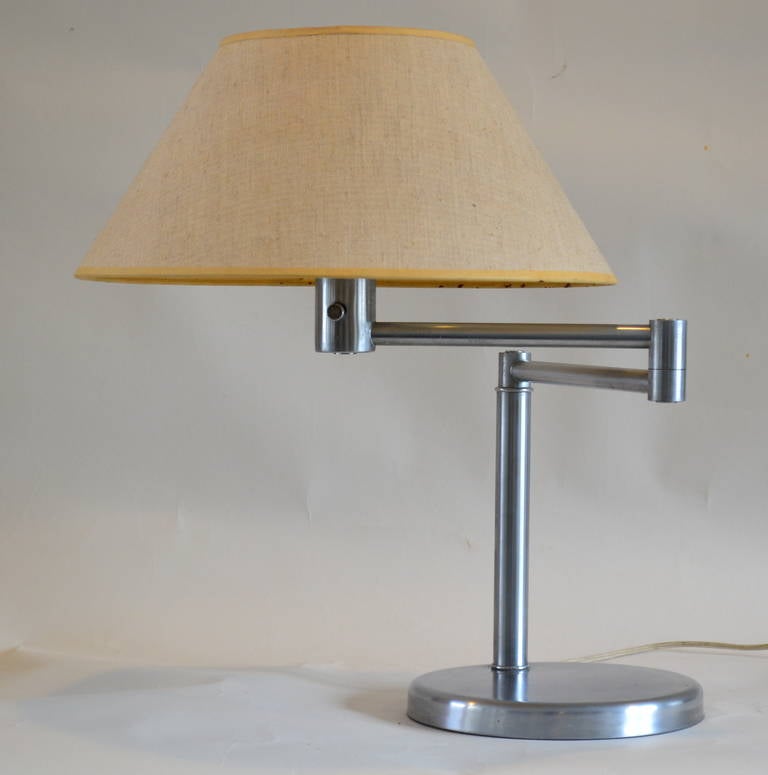 Versatile desk or table lamp was made by Nessen Studios, NY, circa 1940 and is in near perfect original condition. Original glass and shade.