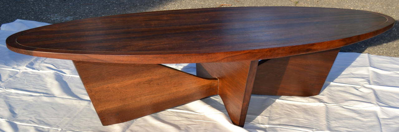 A spectacular rare George Nakashima walnut coffee table. This extremely low production first year model 201 table measures 60 x 22 x 13