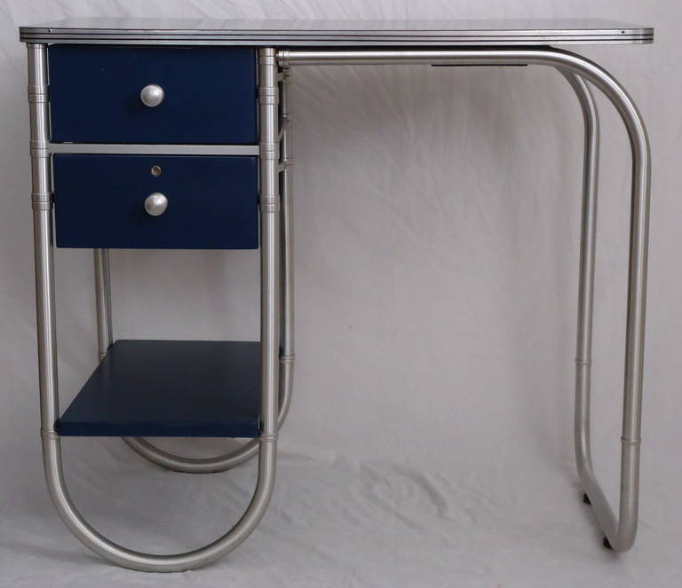 Two drawer writing desk by Warren McArthur.

The desk was professionally restored 25 years ago and has minor wear consistent with gentle use.

When purchased through 1stdibs there is a special flat shipping available for this item to anywhere in