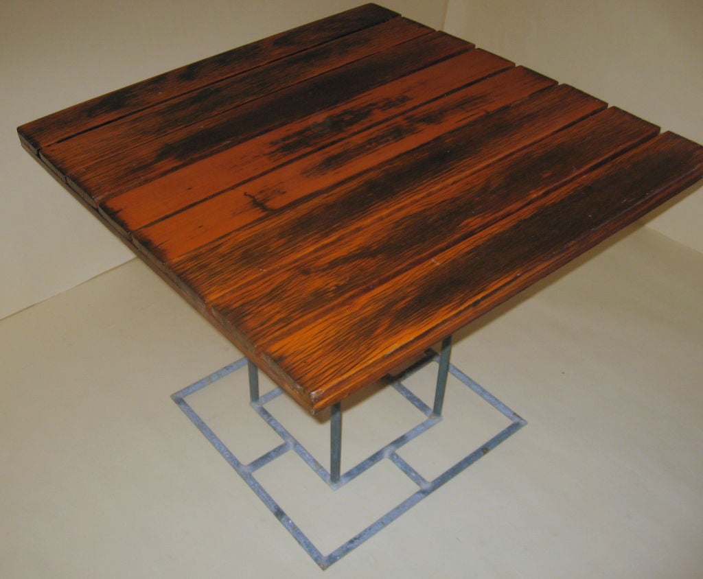 Early example of Walter Lamb manufactured in Hawaii prior to Walter moving back to California in 1947. Koa wood top on a thin tube base from the cafe of a Miami Marina. 

This table has slightly different dimensions when compared to Series One Brown