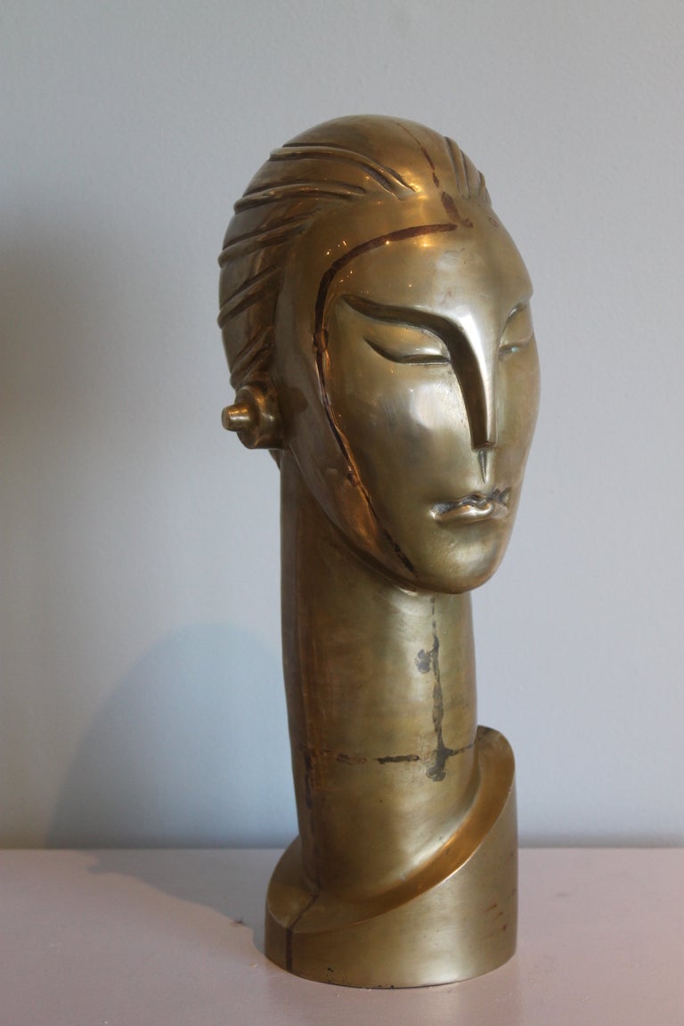 Art deco cast brass stylized female head. Measures 16.5“ high and 7.5” front to back.  Reminds us of the 1927 movie 'Metropolis'. 