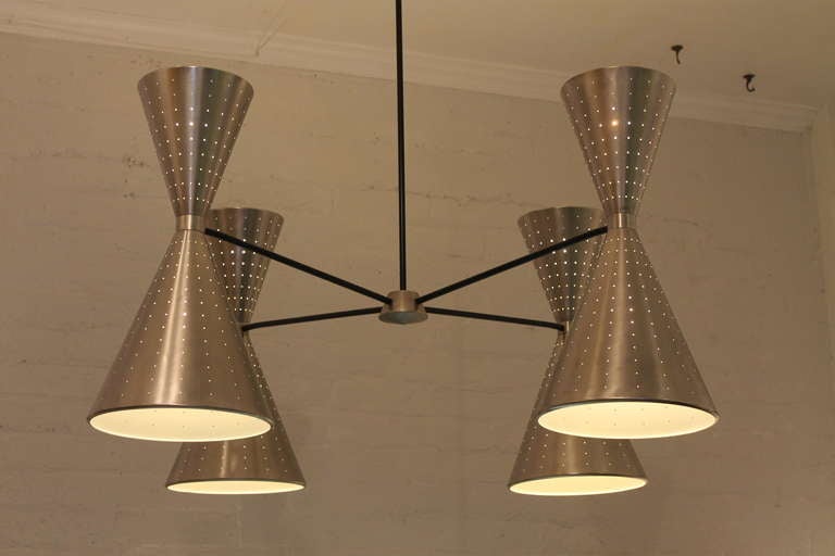 Spun aluminum cone fixture. Massive perforated double cone fixture with up and down lighting. This fixture came out of a circa 1960 bowling alley and is fully restored including all new wiring. It is currently fitted with a 36” drop rod for