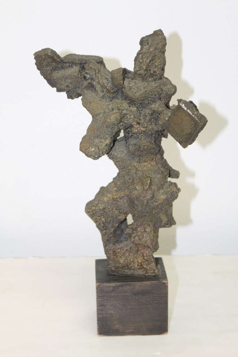 Brutalist bronze sculpture. Heavy cast bronze form on a wooden base. The sculpture alone measures 12” in height. The base, which is 3 1/4” deep and 3 1/2” wide, adds another 3” to the height. Unsigned.