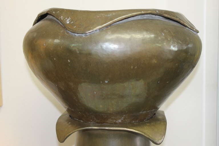 Arts and Crafts copper jardiniere on pedestal, attributed to Limbert.  Retains original patina, the hammered jardiniere with folded edges, above the tapered pedestal having a flared rim.  The top portion is 19" diameter and 11.5" high.