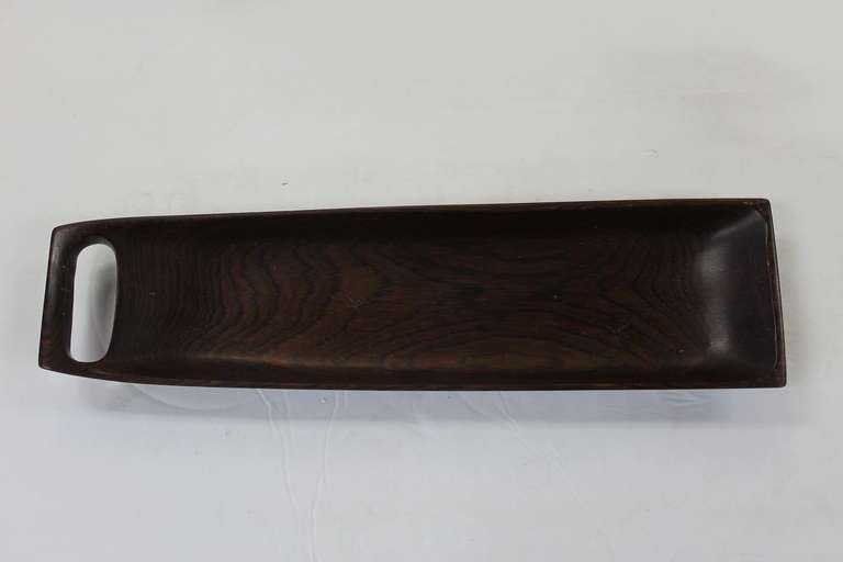 One handled bowl by Jean Gillon, Industria Brasileira. Handmade from Jacaranda wood. Measures 17 3/4