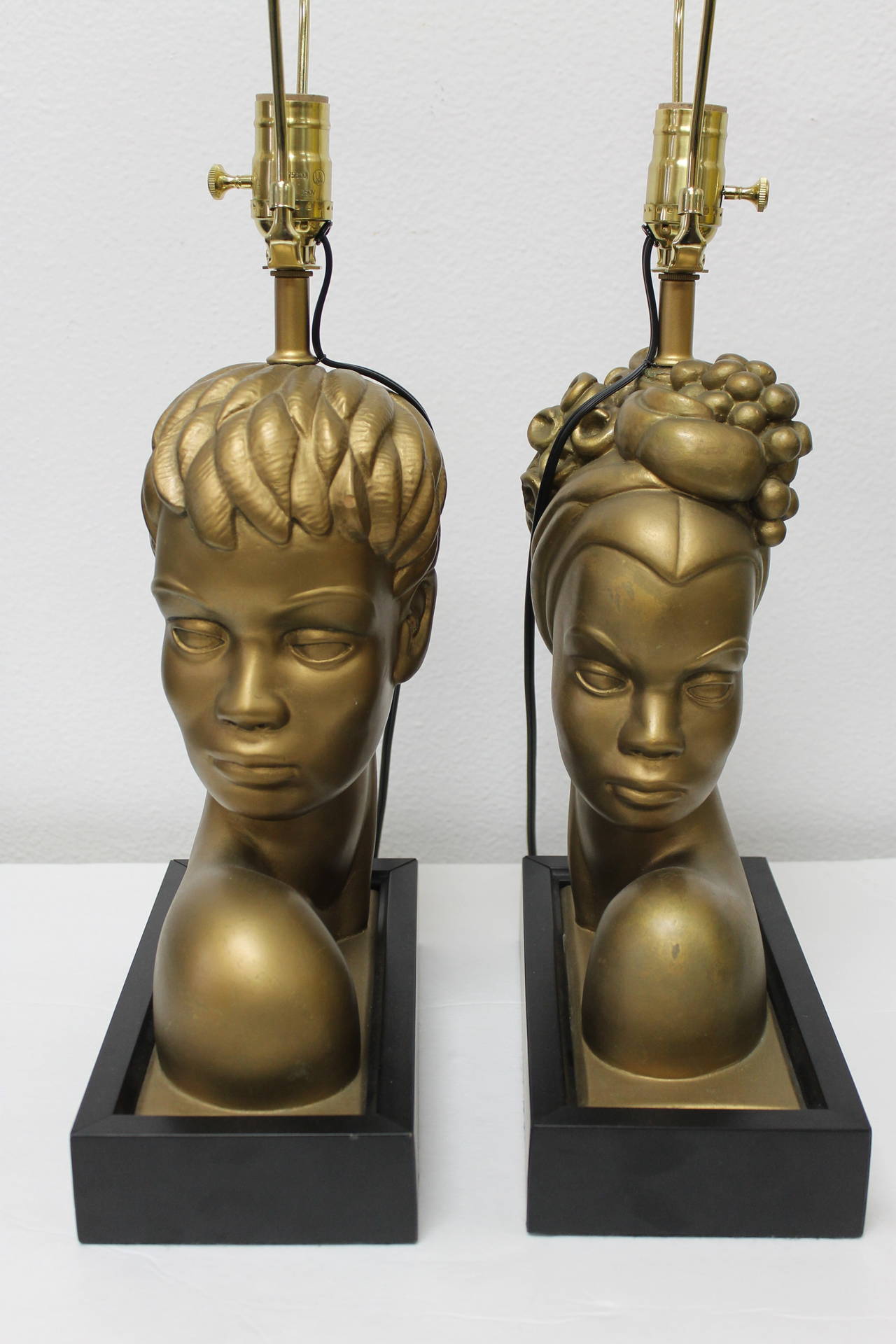 Wonderful pair of custom lamps depicting a Brazilian/Caribbean/Nubian couple. These lamps were produced recently using vintage busts. The base measures 10.25