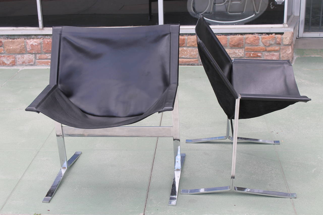 Pair of chairs by Clement Meadmore (1929-2005).  Chrome plated steel base with newly reupholstered leather.  Clement Meadmore is also known for his large sculptures.   These chairs were first shown in a Star Trek episode.  Check out last picture. 