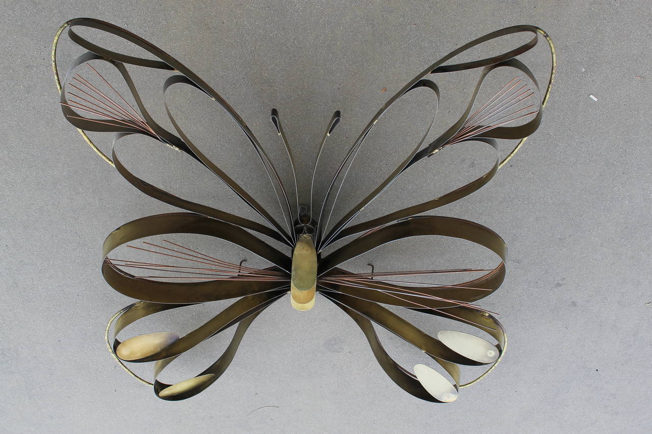 Whimsical butterfly sculpture by Curtis Jere and dated 1978.
