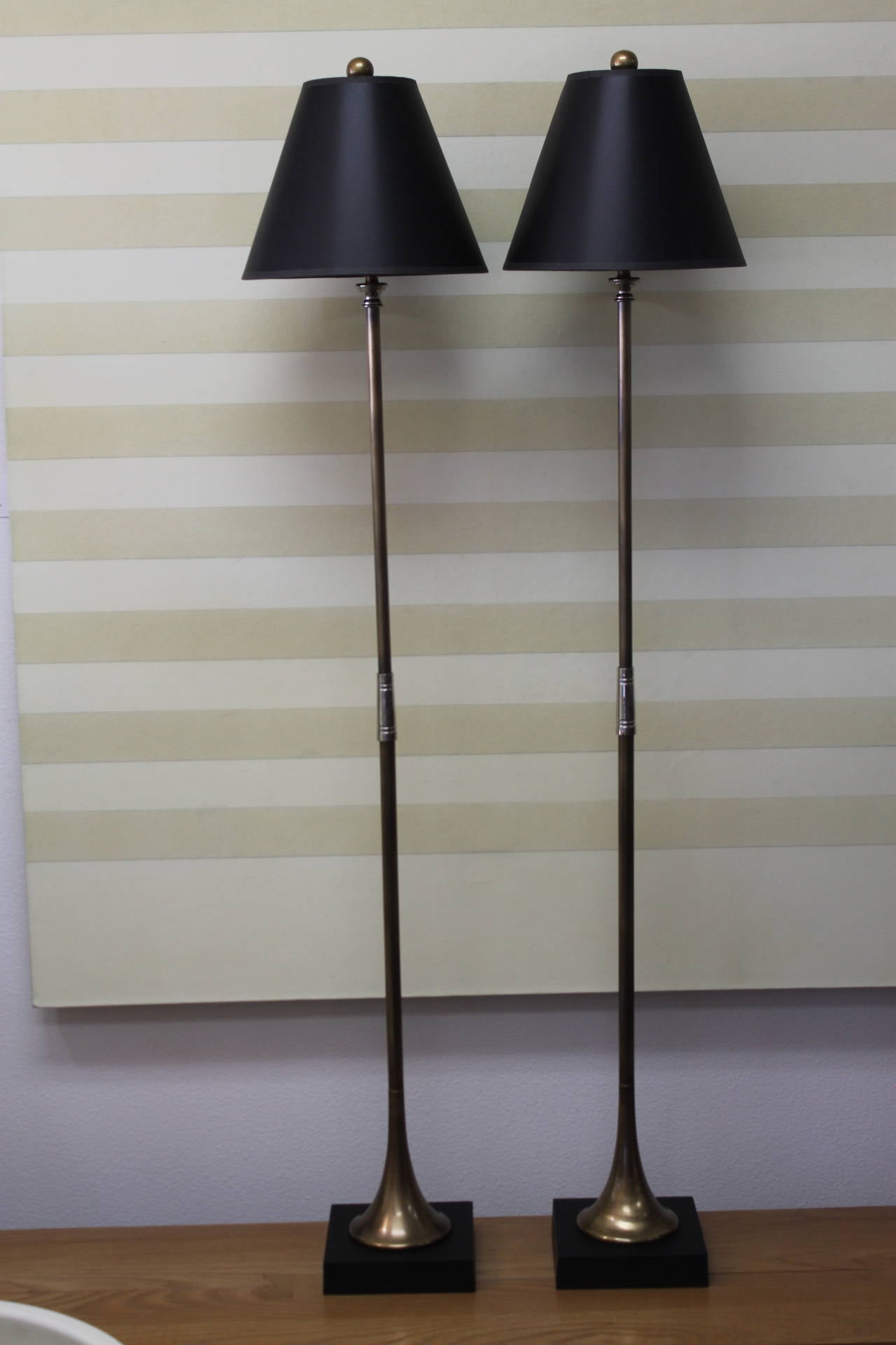 Pair of Chapman trumpet floor lamps. Signed and dated 1972.  Base measures 7" square and 1.75" high.  Trumpet portion measures 44.5" high.  Overall height from base to the top of finial is 56".  Lamp shades are included.