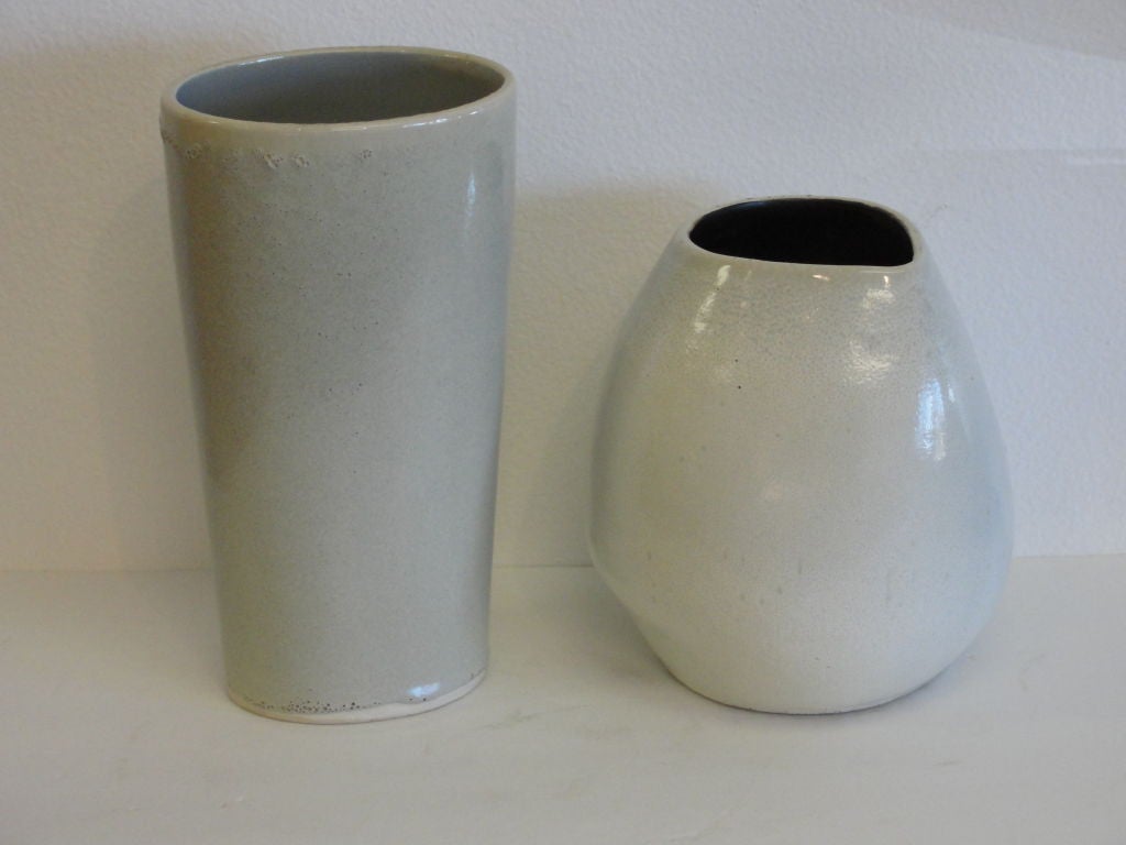 Four Russel Wright Bauer vessels.  This set includes (left to right) candleholder bowl, tapered oval vase, canoe and jug vase.