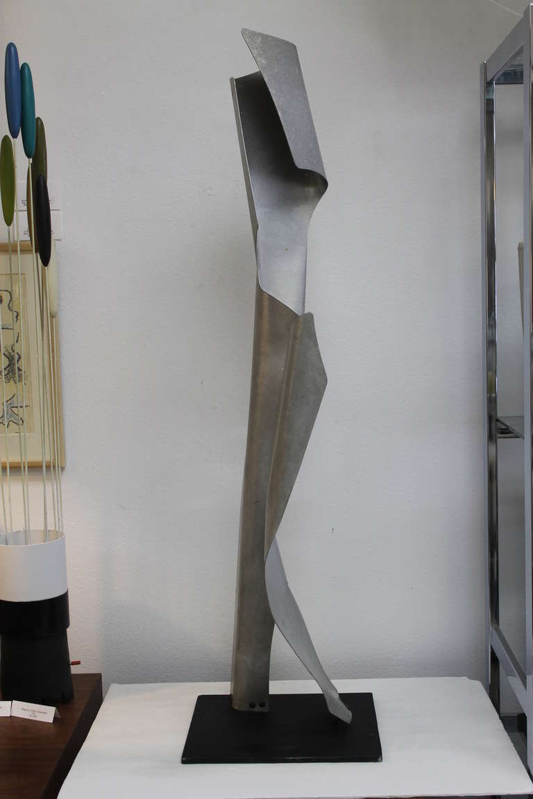 Bent aluminum abstract sculpture by John Chase Lewis. 44” tall with an 11” by 12” steel base. California.