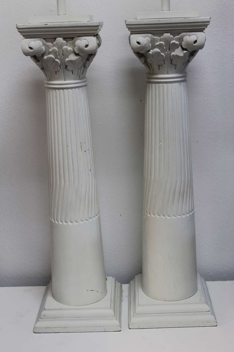 Pair of wood column lamps with incredible white paint patina. Lamps have been professionally rewired and have an on/off switch on the base.  Each lamp measures 34