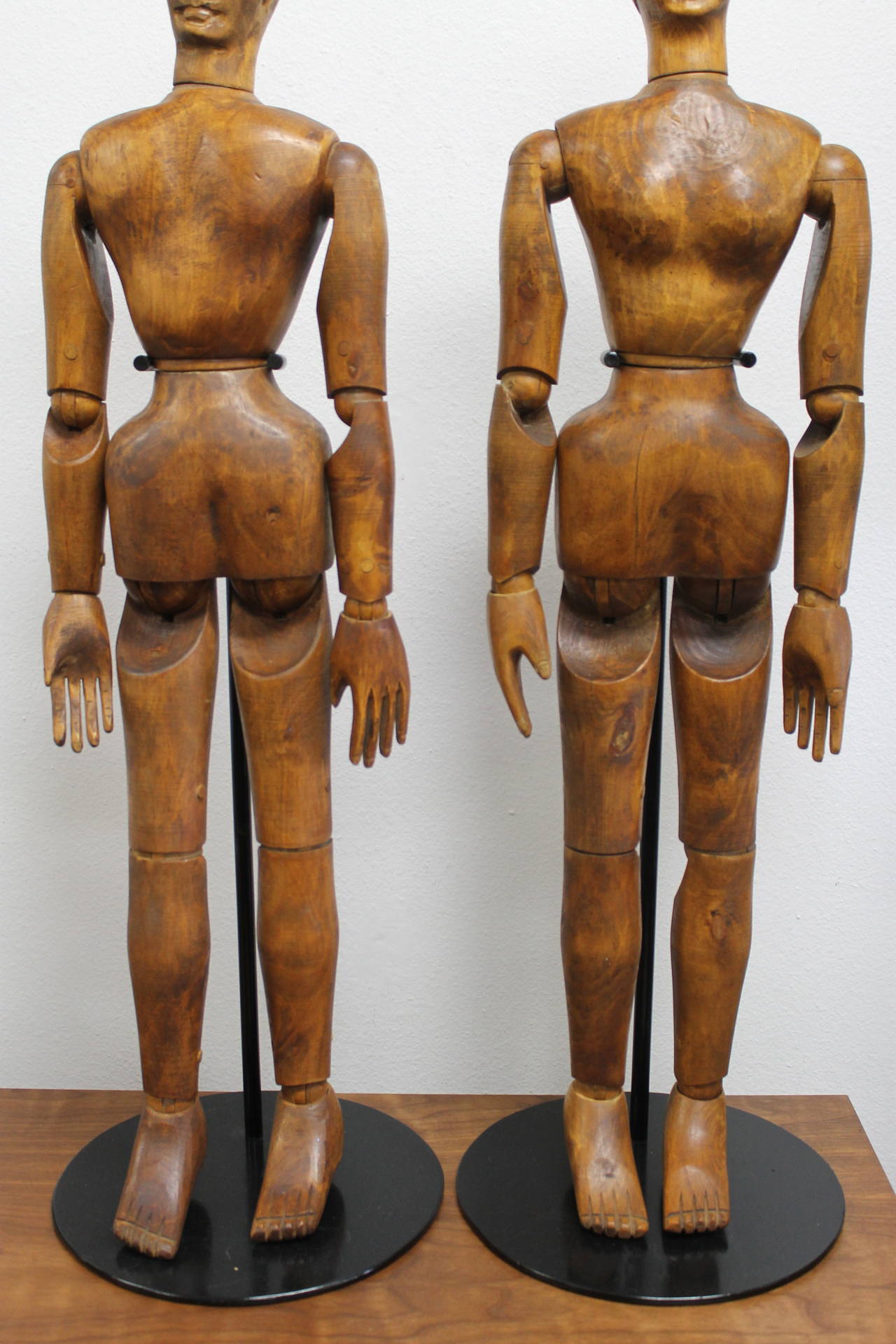 A pair of hand carved mannequinss or models from the turn of the 20th century.  It’s rare to find a male/female pair of articulated wood mannequins in such great condition.  Seems like they’ve been together since they were carved.  These come with