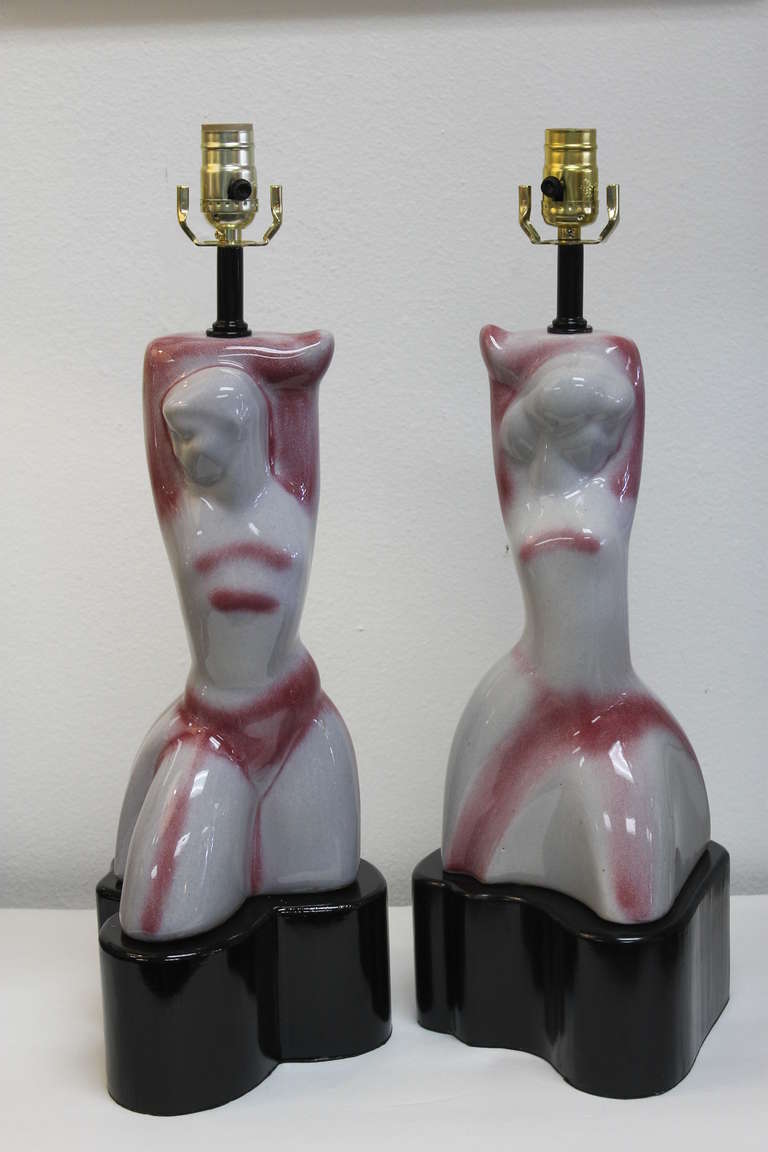 Pair of ceramic stylized lamps attributed to Heifetz. Bases are solid wood and made specifically for these ceramic sculptures. Ceramic portions are 14
