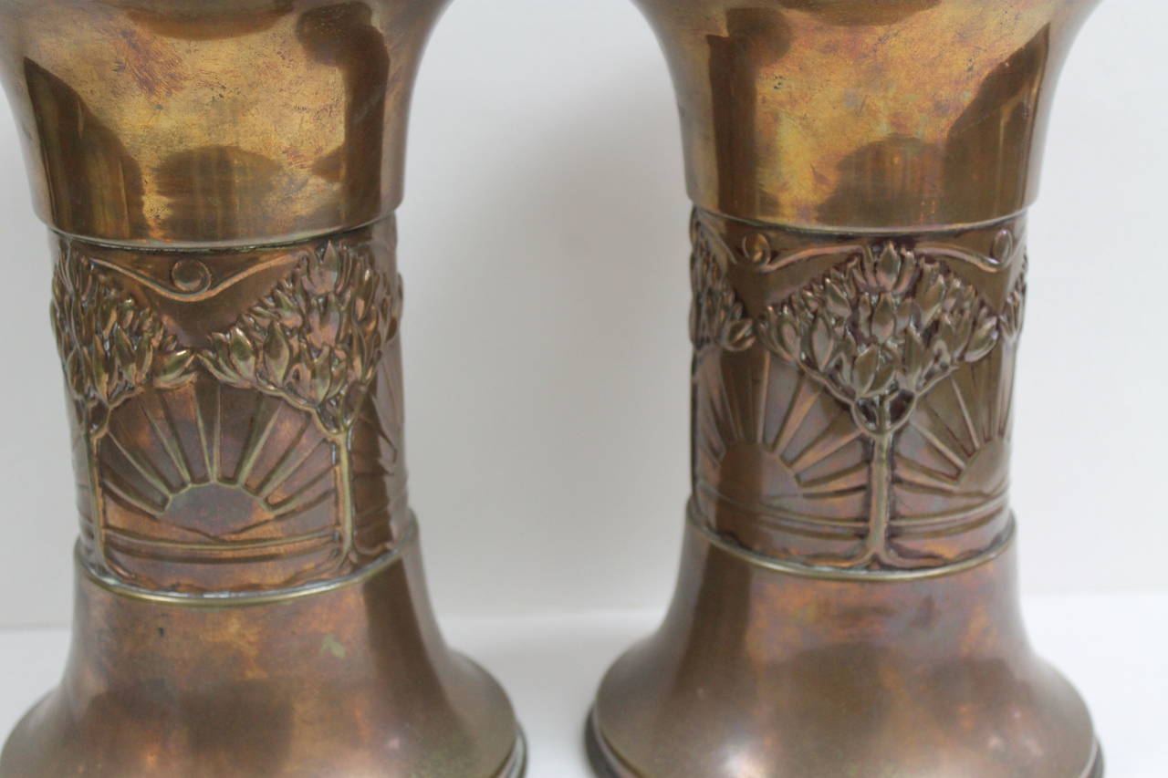 Pair of brass vases. They appear to be brass with a light copper wash. Measure: They are 9.5