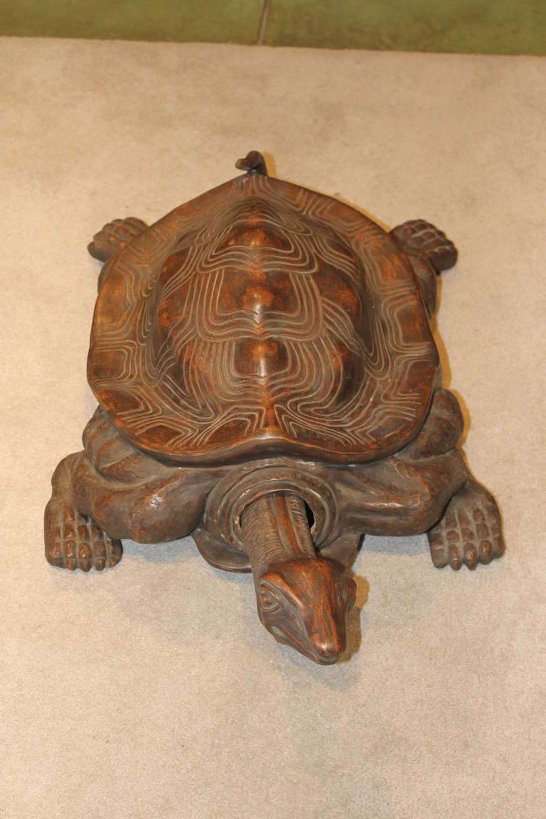 Monumental hand built terra cotta clay tortoise with articulated head, finished with a dark over-glaze. Excellent condition, with one small and old repair under the tortoise’s neck...hidden from view. Unsigned.