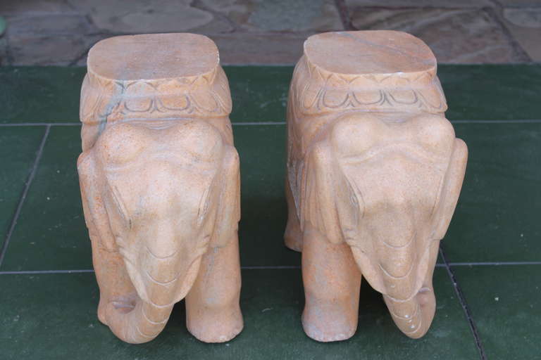 A matching pair of carved elephants, made of solid pale melon colored marble. Excellent condition with very minor chipping to some edges.