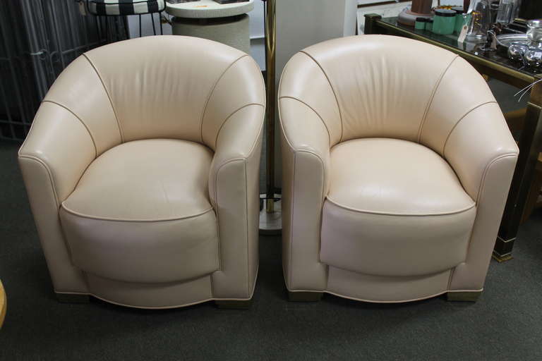 Art Deco inspired chairs covered in a rich peach leather.  Reminiscent of Ward Bennett's designs for Brickel.  Extremely comfortable.  Not suure of the age, so we're going to say they're from the 1950's.