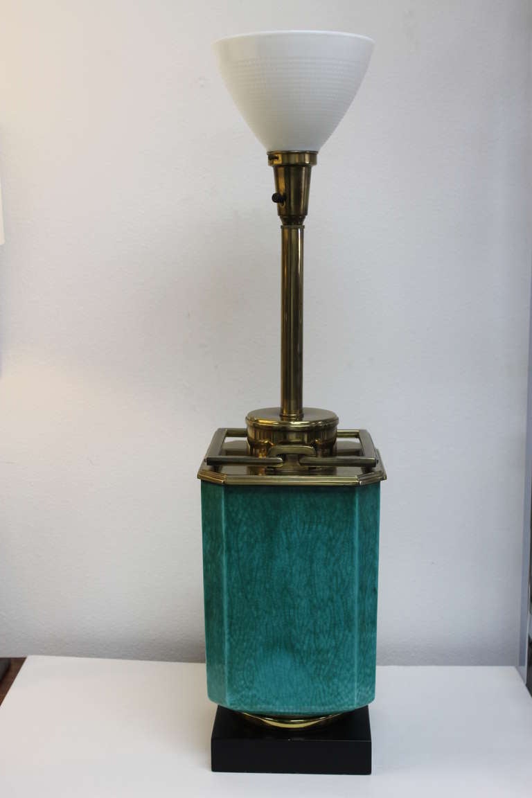 Elegently styled square table lamp with a Malachite green crackle glazed body, black painted wood base and polished brass upper fittings. The hinged brass handles are reminiscent of those on a Chinese lantern. The green ceramic portion alone