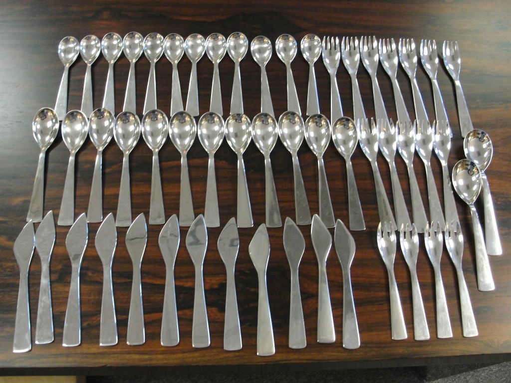 Gio Ponti stainless steel flatware service for 12.  Comprising of 12 knifes, 12 dinner forks, 12 soup spoons, 12 tea spoons, 4 salad forks and 2 over sized serving spoons. Impressed 