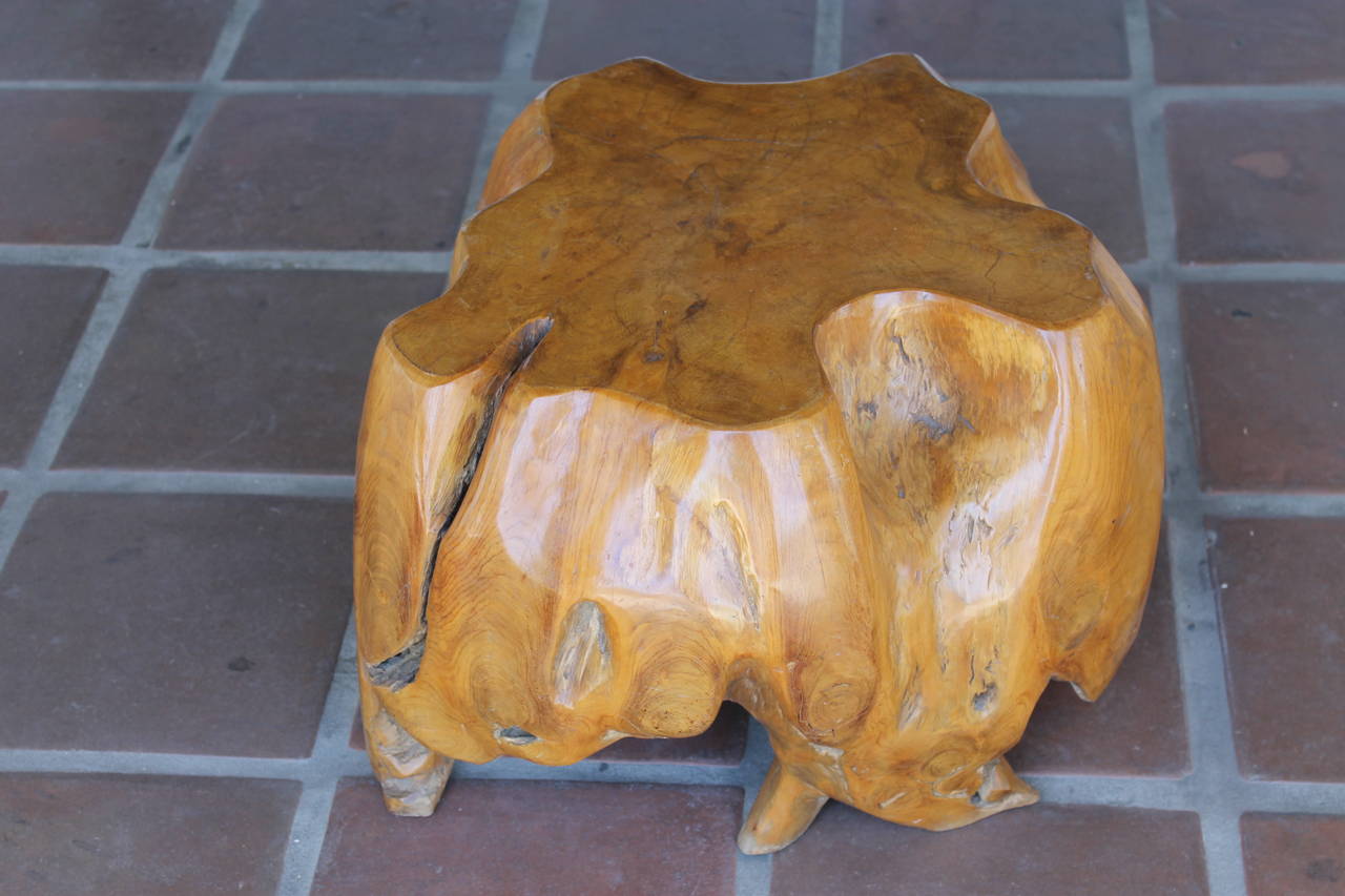 This redwood burl tree stump has been carefully carved and polished to accentuate the intricate formation of roots beneath the free-form top surface. circa 1970s. Rich caramel color. Heavy piece. Height 15