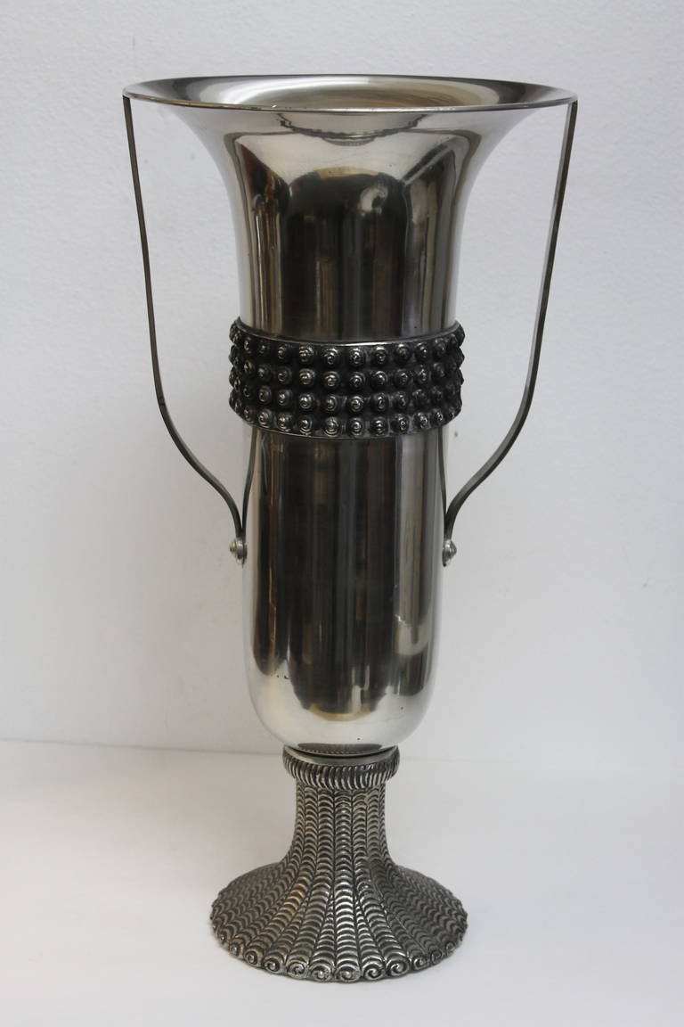 Extremely tall and sleek double armed chalice form in nickel plated brass with heavy studded band and sculpted base. Unsigned and possibly Scandinavian.