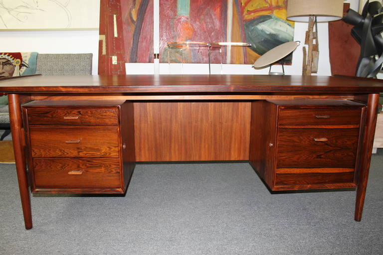 Rosewood and teak desk attributed be designer Arne Vodder, manufactured at Sibast Mobler.  The width between the drawers is 28