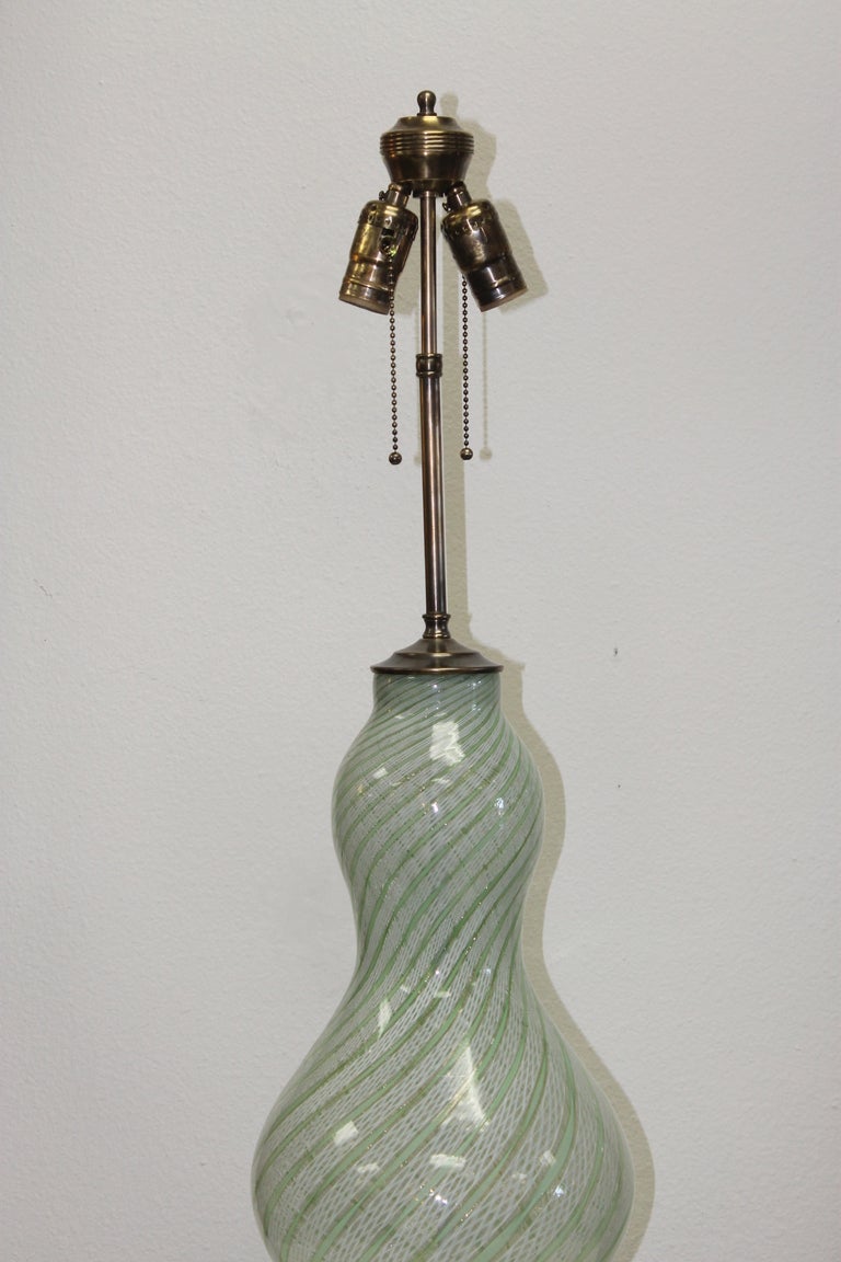 Murano lamp consisting of green, gold and white. Lamp measures 33