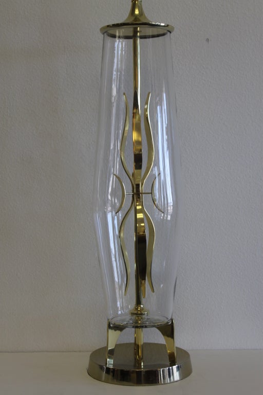Lampe en laiton et verre attribuée à la Laurel Lamp Co.  Constitué de verre contenant une sculpture en laiton. La lampe mesure 51