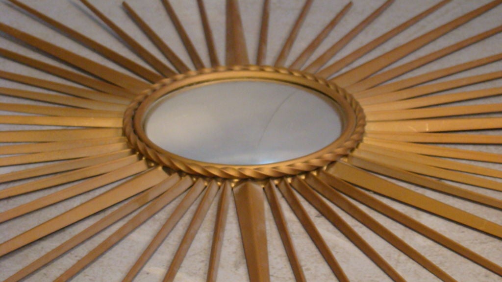 CHATY VALLAURIS LACQUERED METAL SUNBURST MIRROR<br />
SIGNED ON THE BACK