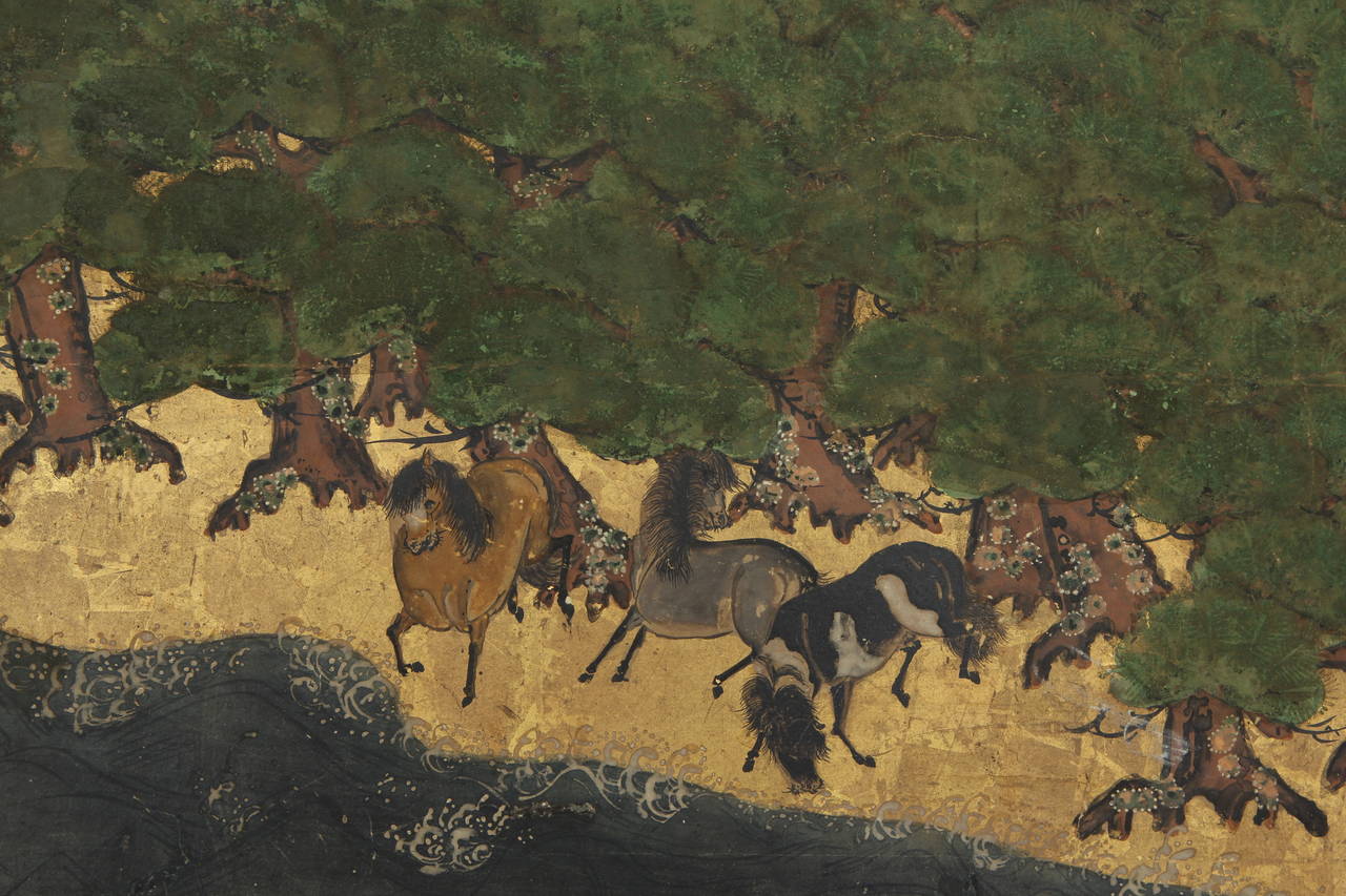 Detailed painting in ink and mineral pigments on paper with gold leaf. Scene of ten horses under pines by the ocean shore. In the background travelers by a village and on the right a boat.