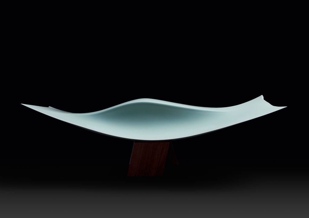 Porcelain sculpture with seihakuji pale-blue glaze.  On a solid walnut stand.

Nr 3 from an edition of 8.