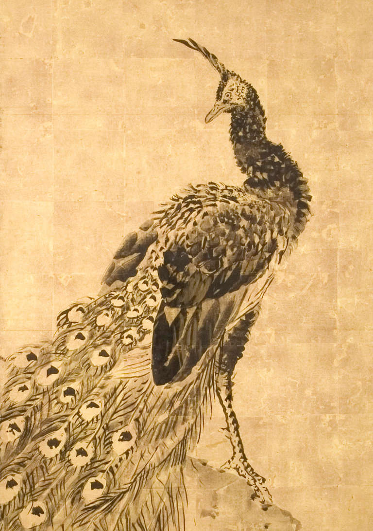 Two-panel folding screen with a large peacock standing on a rock by bamboo; bold painting in ink on gold leaf, signed to the right with the seal mark of the artist. Signed 