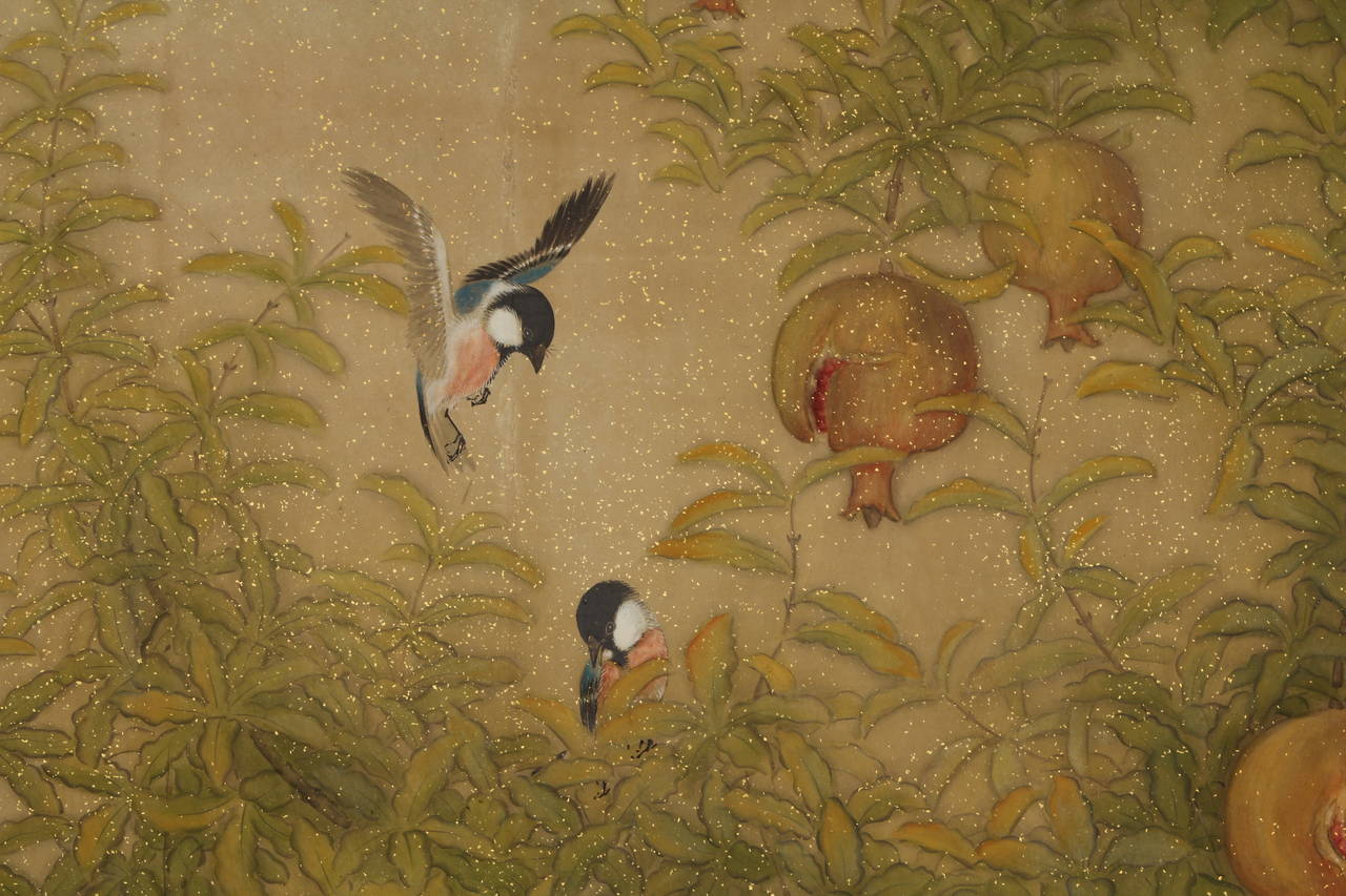 Two-panel folding screen with fine painting in ink, mineral colors, and gold leaf on paper of a pair of birds flying by a pomegranate tree. Signed by the artist with two red seals: Nakaoka (Student of Yamamoto Shunkyo, ac. Taisho- early Showa eras).