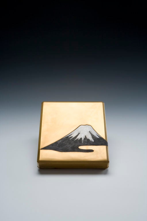 Suzuribako writing box with décor of Mount Fuji on a gold lacquer ground, the inside with gold lacquer waves on black ground; comes with a fine silver and gold suiteki in shape of a flying crane, the original suzuri ink stone and a the original