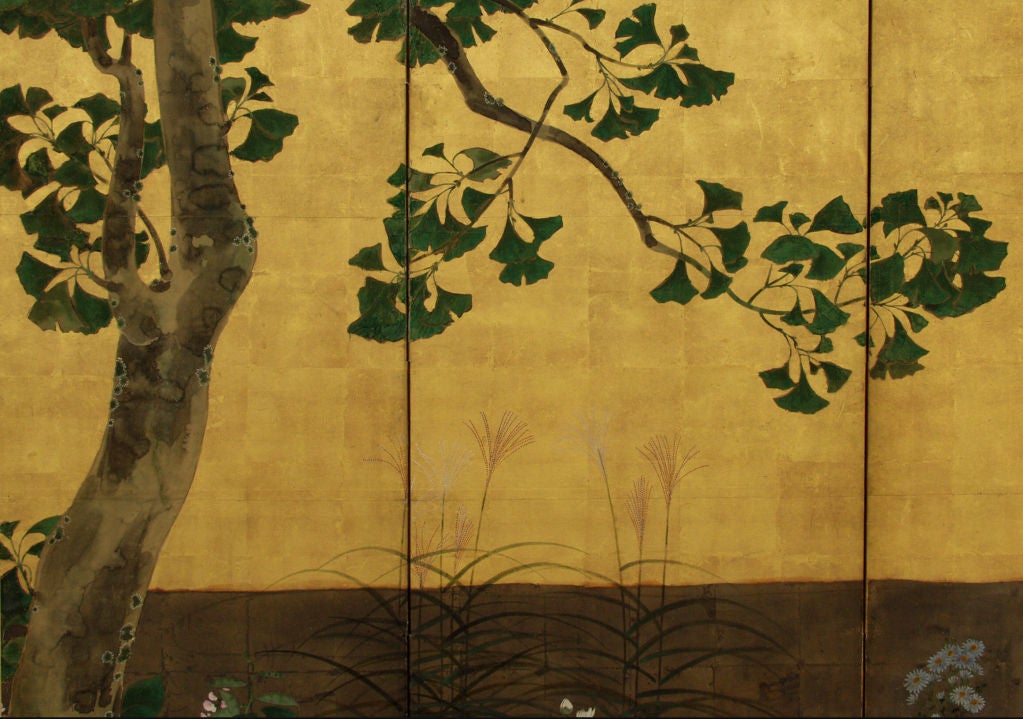 Six-panel folding screen with a gingko tree and seasonal flowers by a meandering stream.<br />
Painting in ink, mineral colors and gofun (ground sea shell powder) on paper with gold and silver leaf.<br />
The green color is made of ground