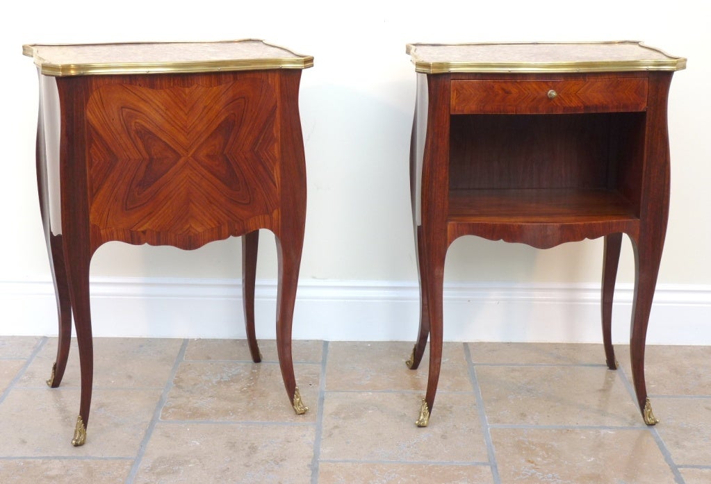 A Pair of Wonderful quality French Kingwood Bombe side tables with a shaped marble top set within a gilt brass border. The elegant tapering cabriole legs are finished with detailed bronze mounts.