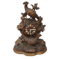 A Swiss 'Black Forest' Carved Clock