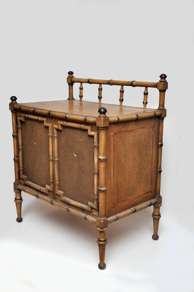 Faux Bamboo Two Door Cabinet, early 20th century
the top with an unusual raised railing detail, and each door having a basketweaved pattern.