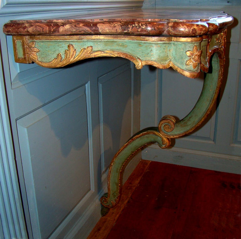 French Régence one leg console table with original painted blue/green surface, the gilt is also original with only minor restoration.   This console is a superb example of French Régence Rococo, with outstanding form and delicate rococo leaf